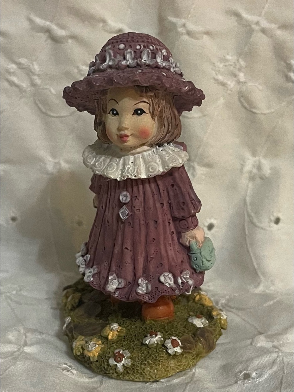 Beautiful ceramic figurine of a girl in the countryside, home decor. Ceramic